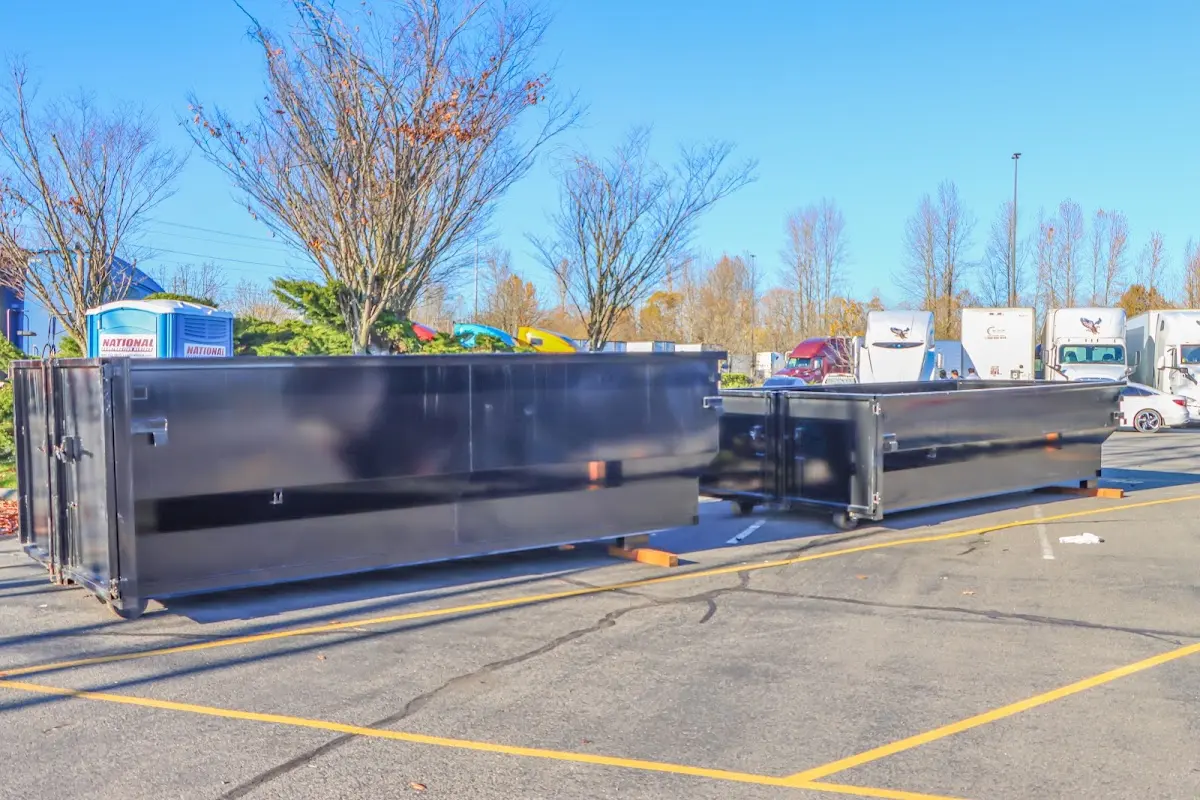 Professional dumpster rental service with roll-off container on residential driveway in Sullivan